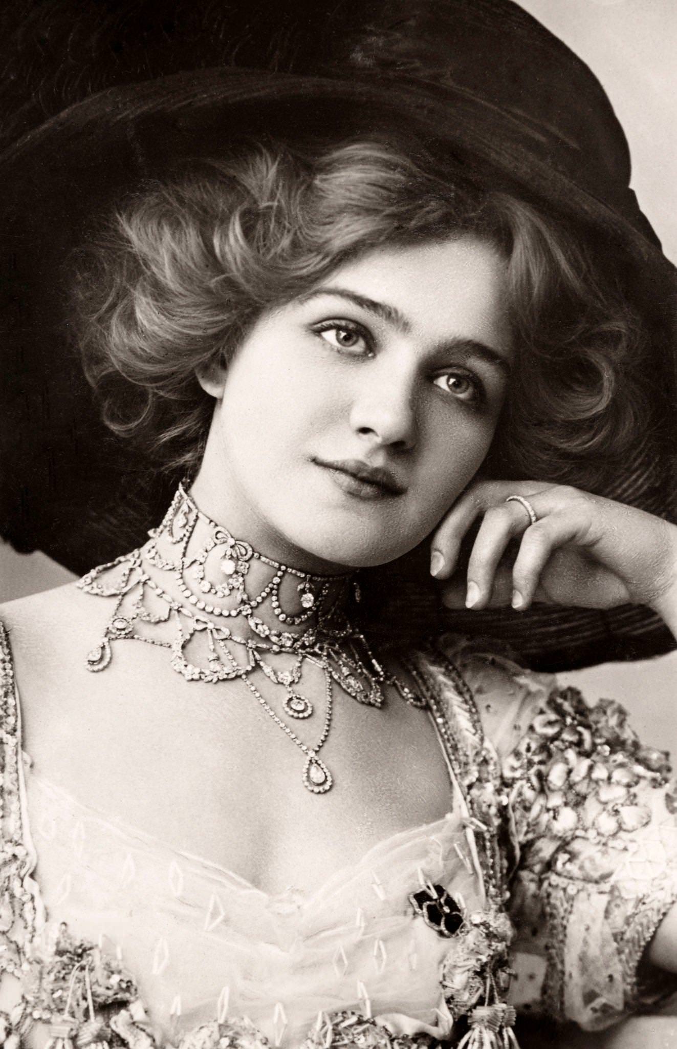 #30 Lily Elsie, an English actress and singer, poses elegantly for the camera
