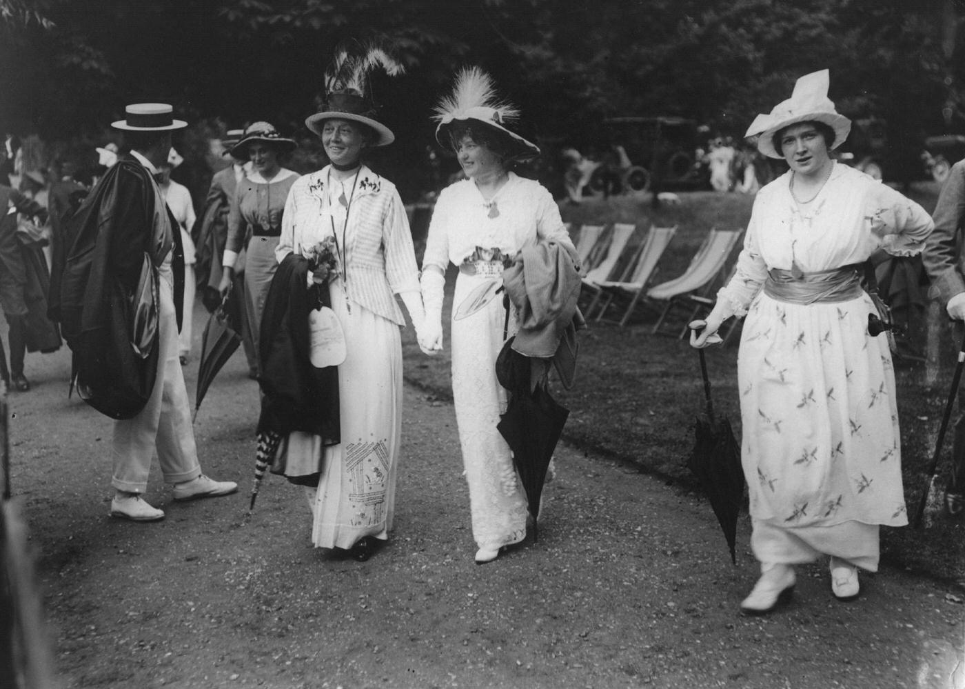 #32 A group of women donning fashionable dresses and hats of the Edwardian era