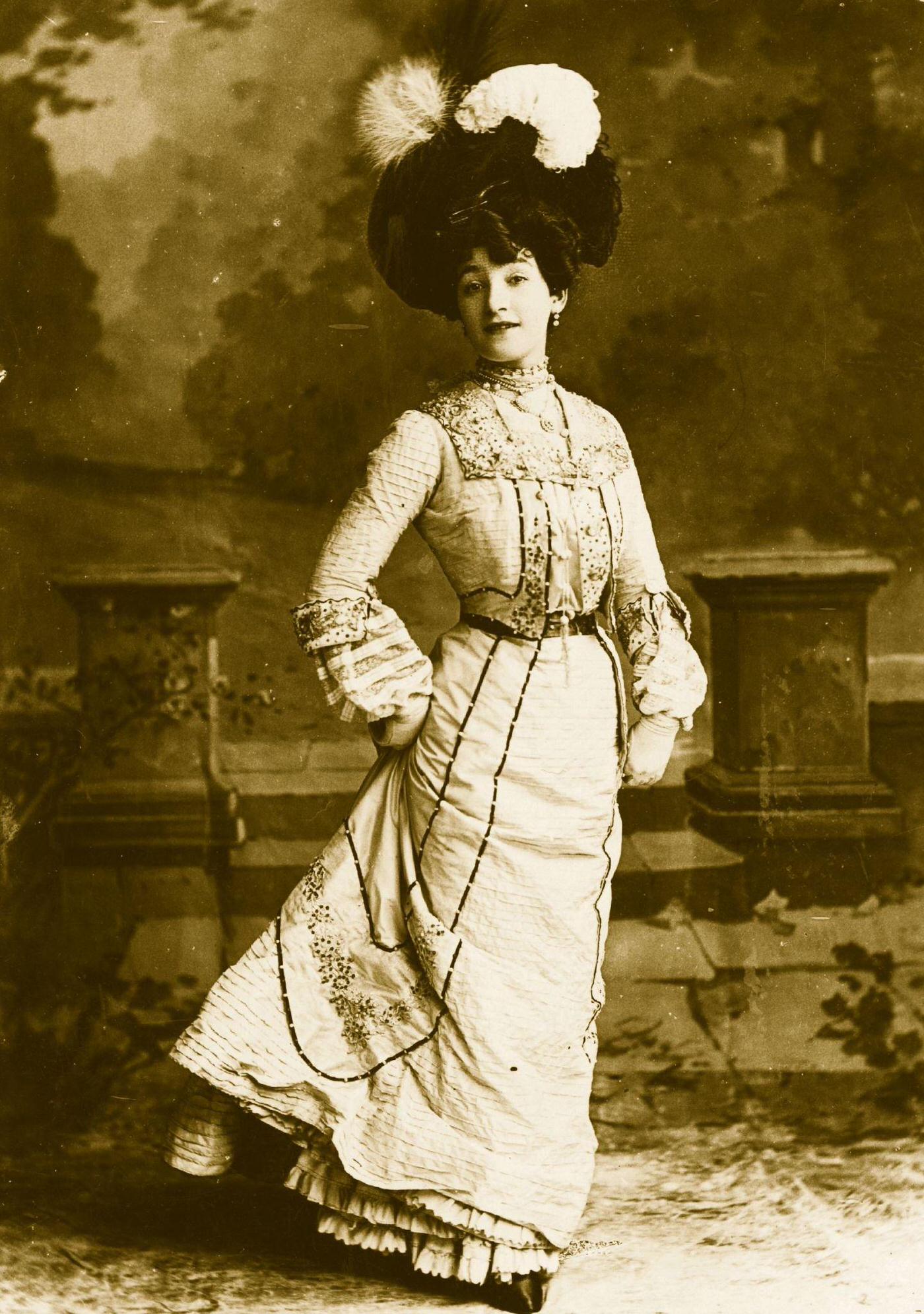 #52 A proud Edwardian lady poses in street dress for a studio portrait