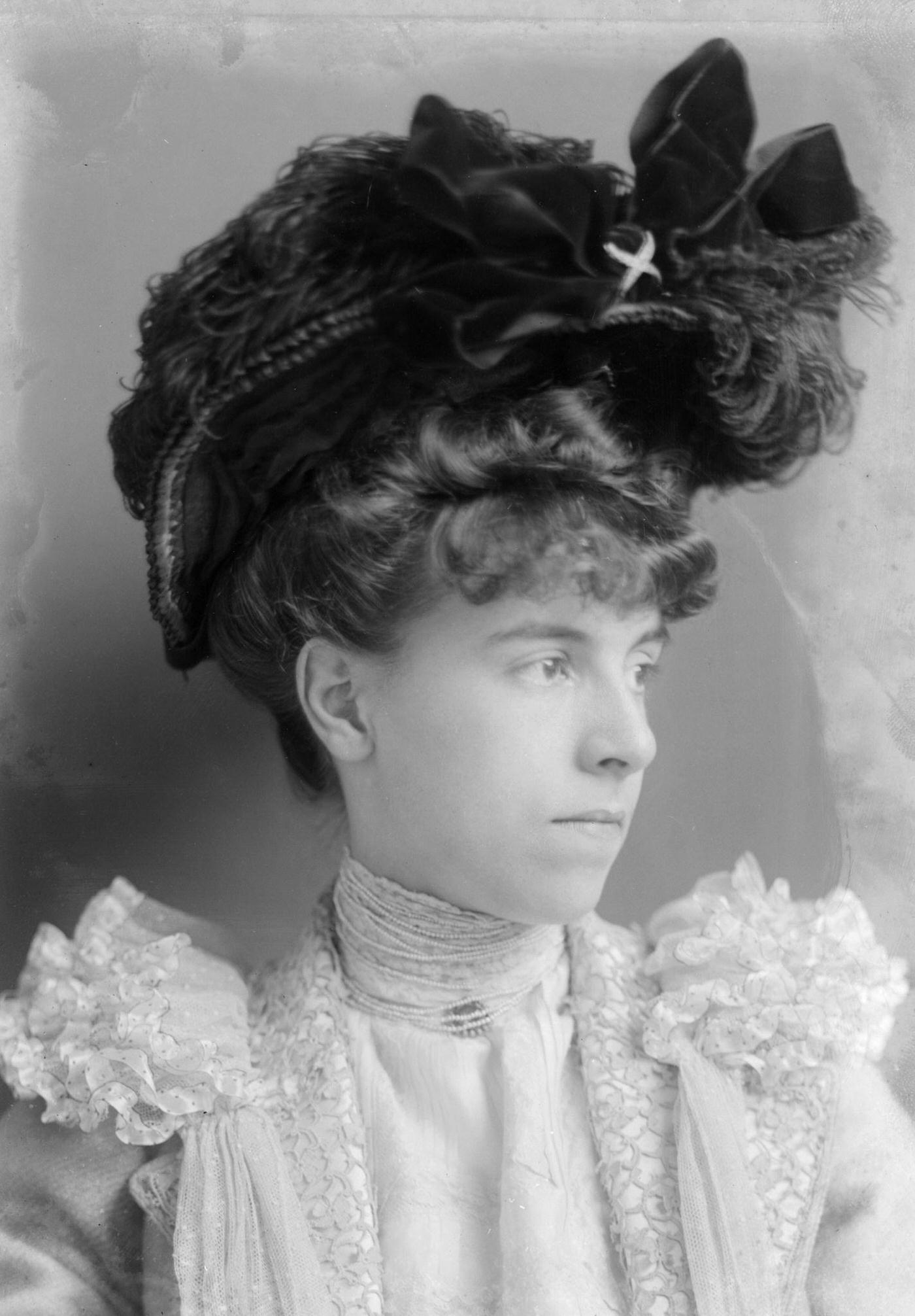 #59 Miss M. Stephenson poses for a formal portrait wearing a typical Edwardian hat in 1902