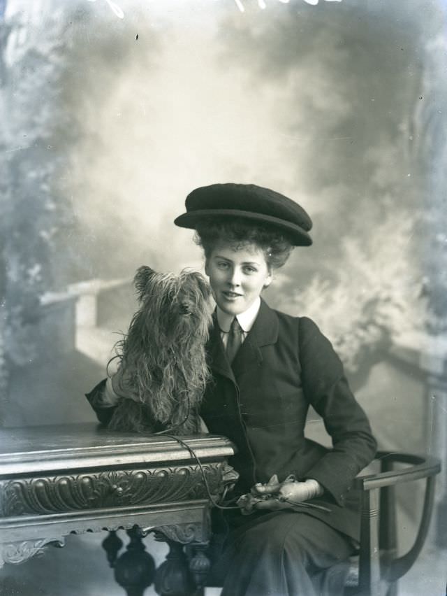 #97 Miss Taylor poses with her dog for a portrait in 1906
