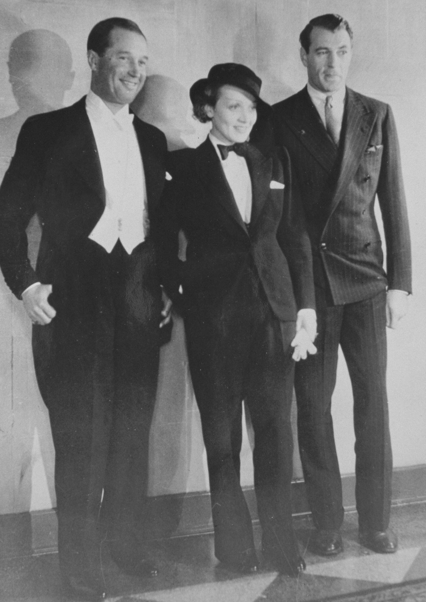 #1 Maurice Chevalier (left) and Gary Cooper flank Marlene Dietrich dressed in a tuxedo.