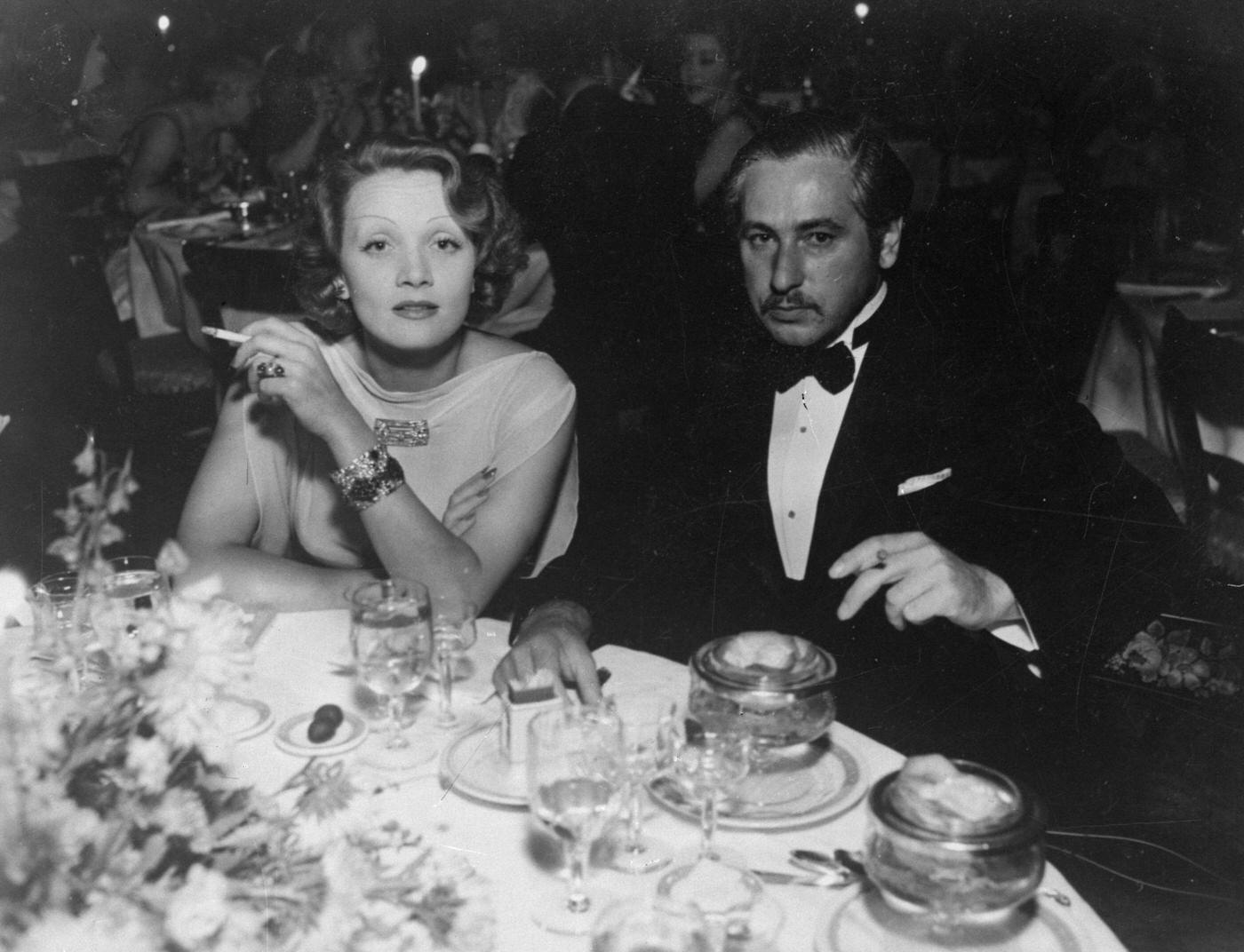 #59 Marlene Dietrich dines with director Josef von Sternberg in 1935.