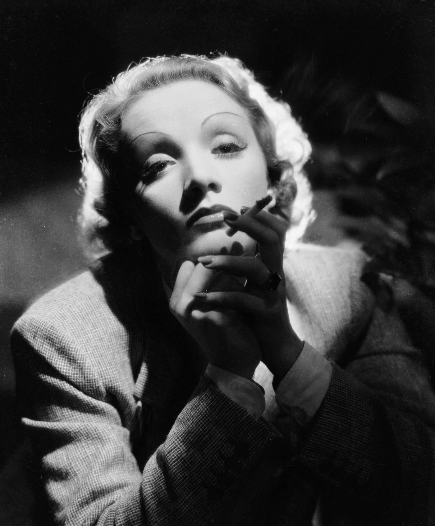 #60 Marlene Dietrich oozes sensuality while smoking in the 1930s.