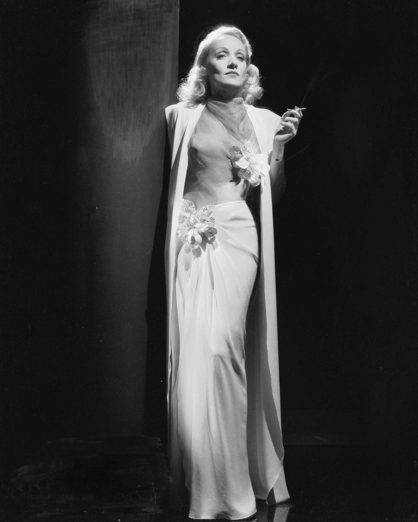 #18 Marlene Dietrich looks stunning in an elegant white dress from 1937.