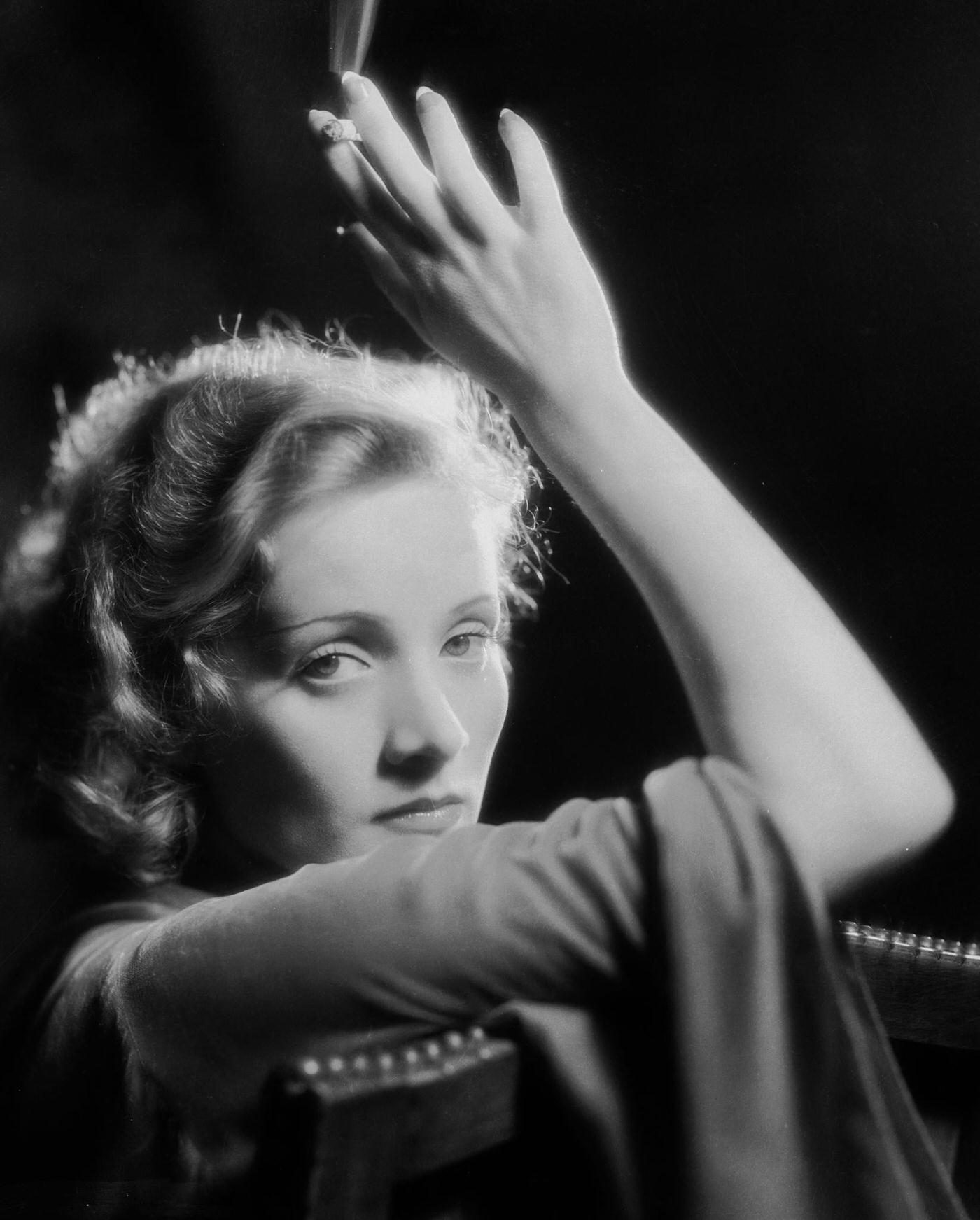 #48 A photograph of Marlene Dietrich smoking.