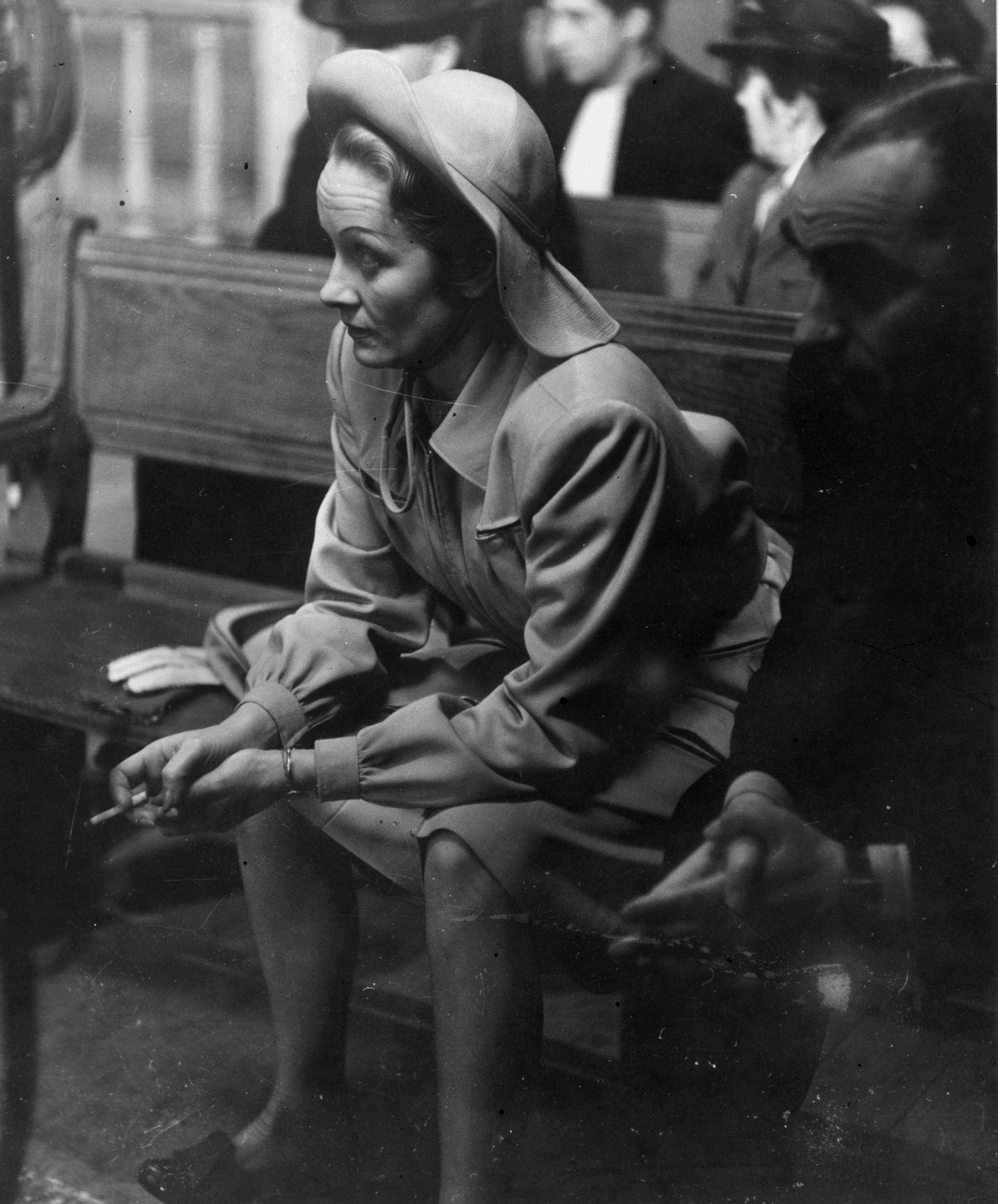 #28 Marlene Dietrich takes a cigarette break during the filming of ‘Martin Roumagnac’ in 1944.