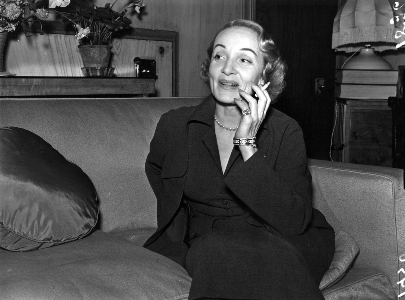 #35 Marlene Dietrich is captured smoking in 1950.