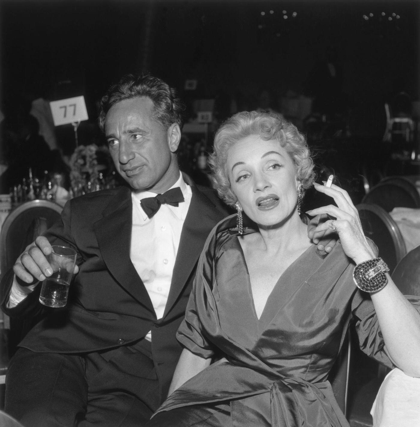 #38 Elia Kazan and Marlene Dietrich sit together at the premiere reception for director George Cukor’s film ‘A Star is Born’ in the 1950s.