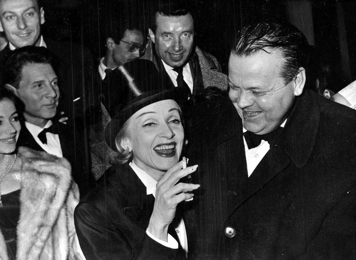 #43 Marlene Dietrich shares a joke with US actor and director Orson Welles in 1958.