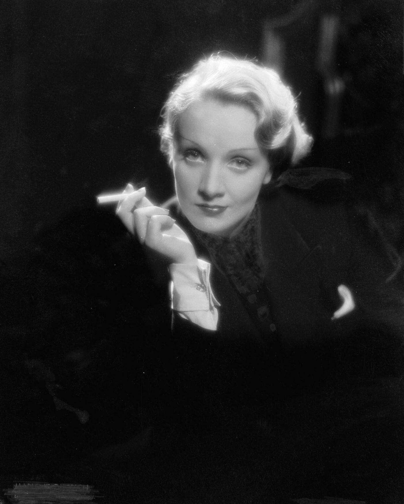 #50 Marlene Dietrich captured smoking in a photograph.