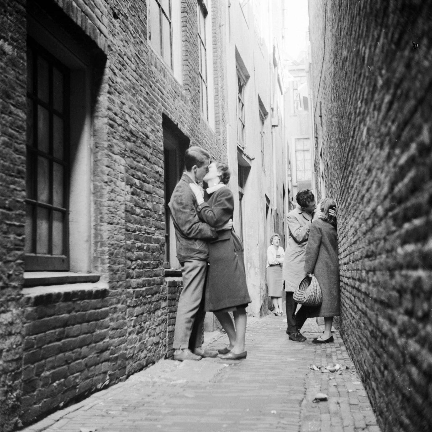 #11 Couples kissing in a narrow alley in the Netherlands, circa 1956.