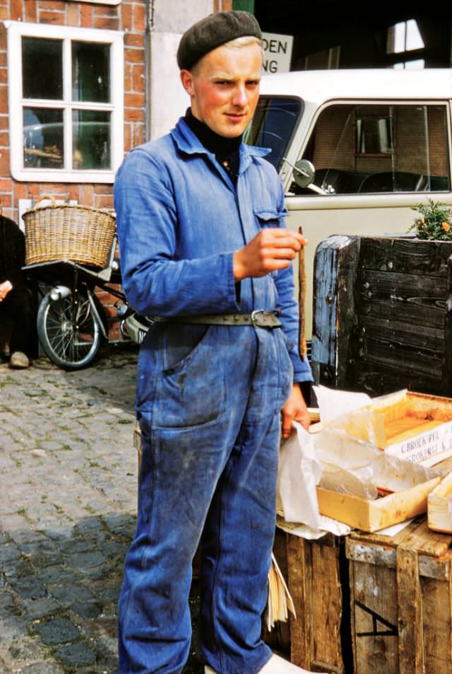 #102 A fishery worker on a break holding a smoked eel, Veere Netherlands.