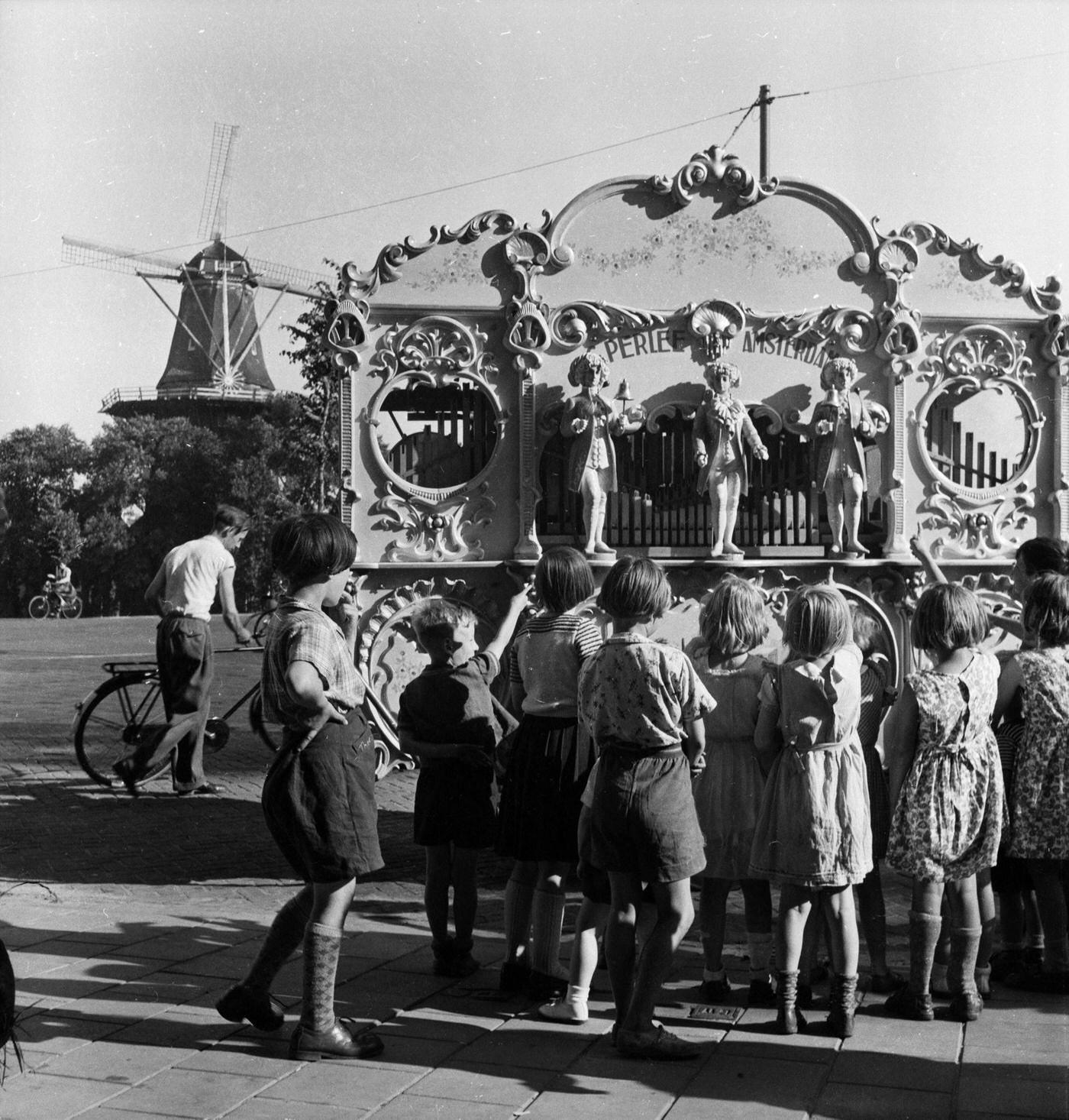 #18 Only three organ-grinders licensed to take an organ into the main streets of Amsterdam, compared to about fifty before the war, 1955.