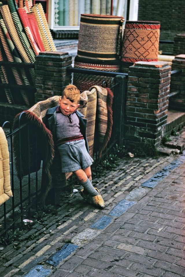 #69 A young boy outside carpet shop, Volendam.