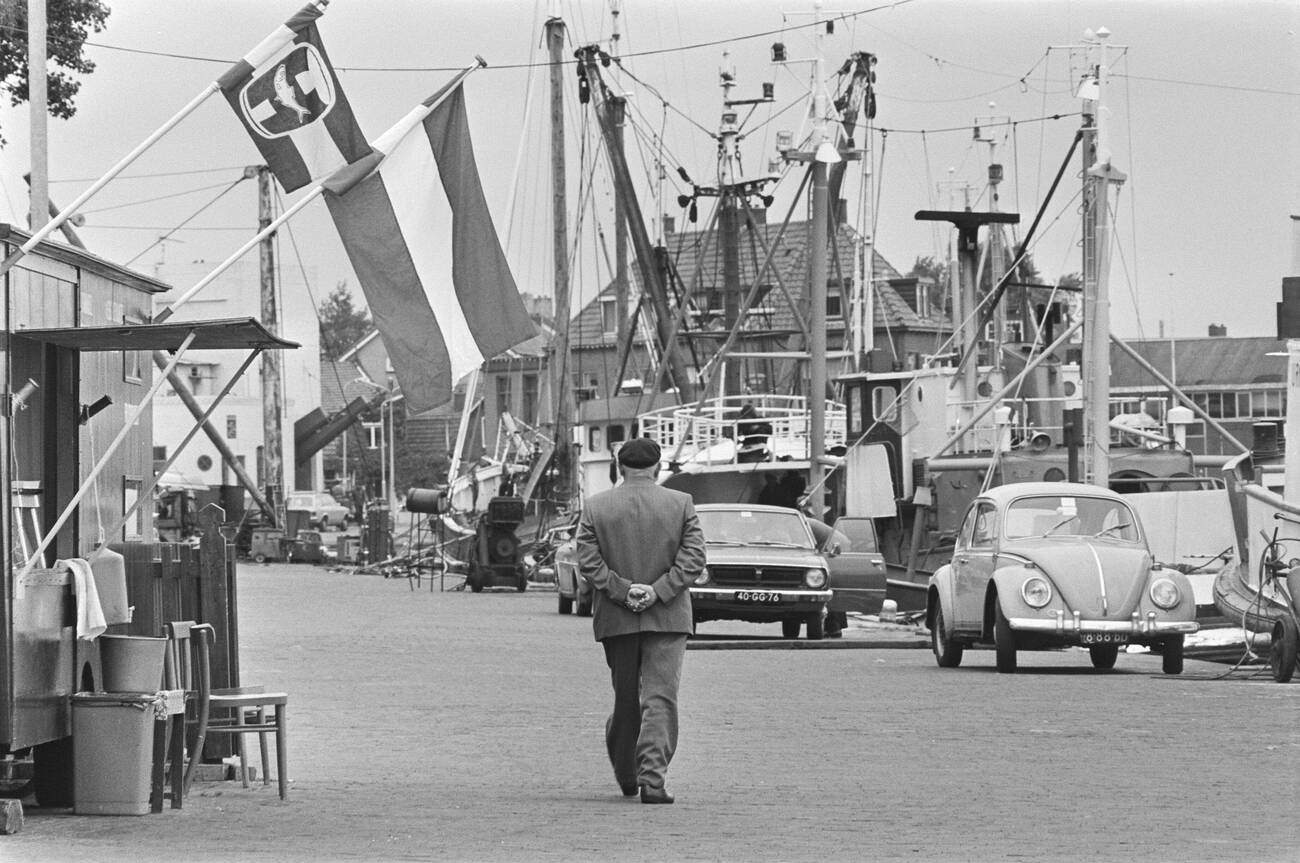 #13 Fishing boats in the harbor of Urk and Urker in traditional costume around June 2, 1976.