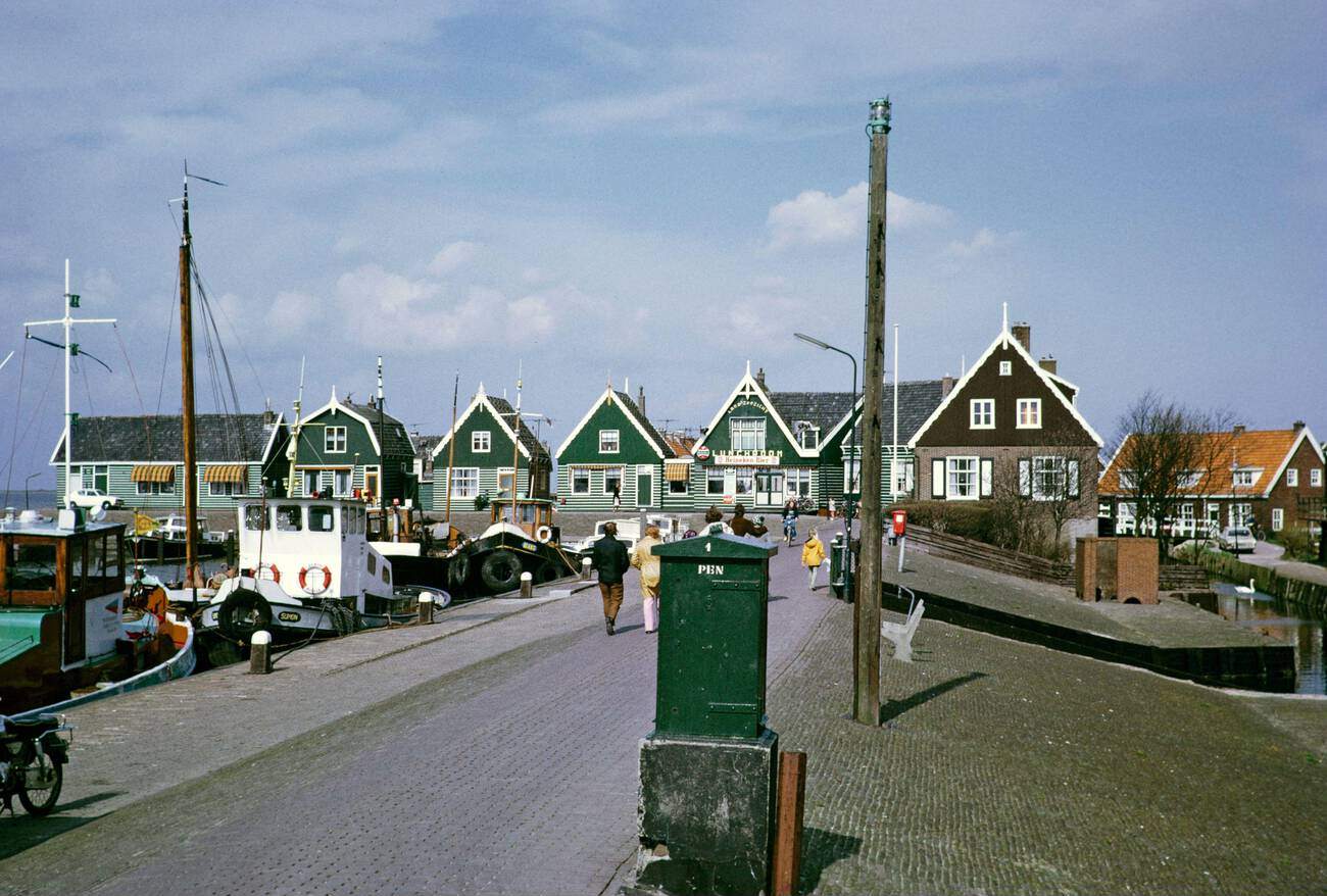 #38 Fishing boats in harbor by traditional village houses, Marken: Traditional village houses and fishing boats in the picturesque harbor of Marken, in 1973.
