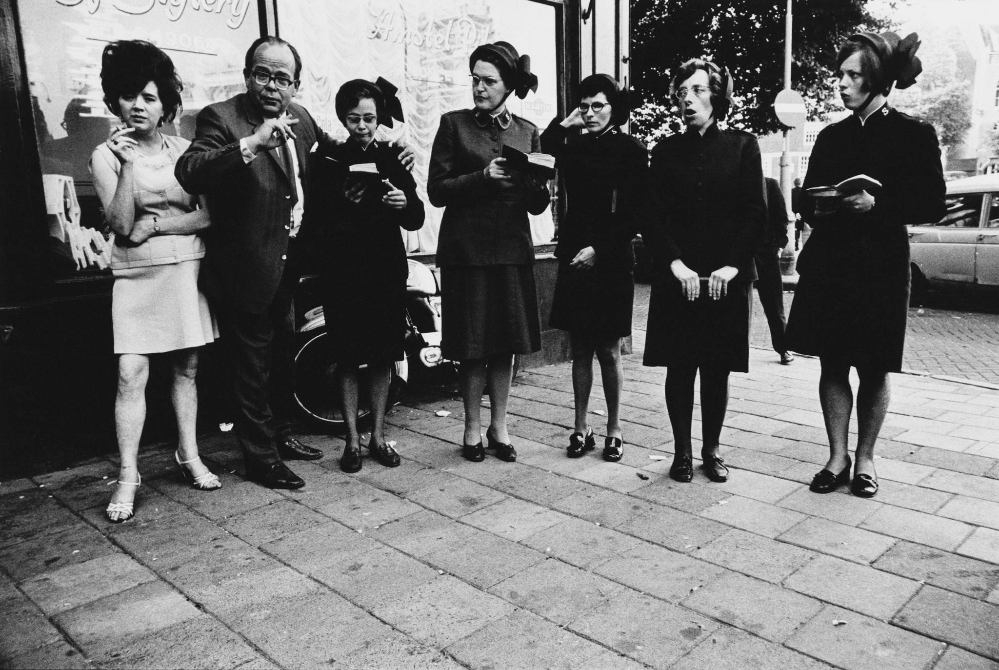 #79 The Salvation Army singing worship songs outside a bar in Amsterdam, capital city of the Netherlands, 1970.