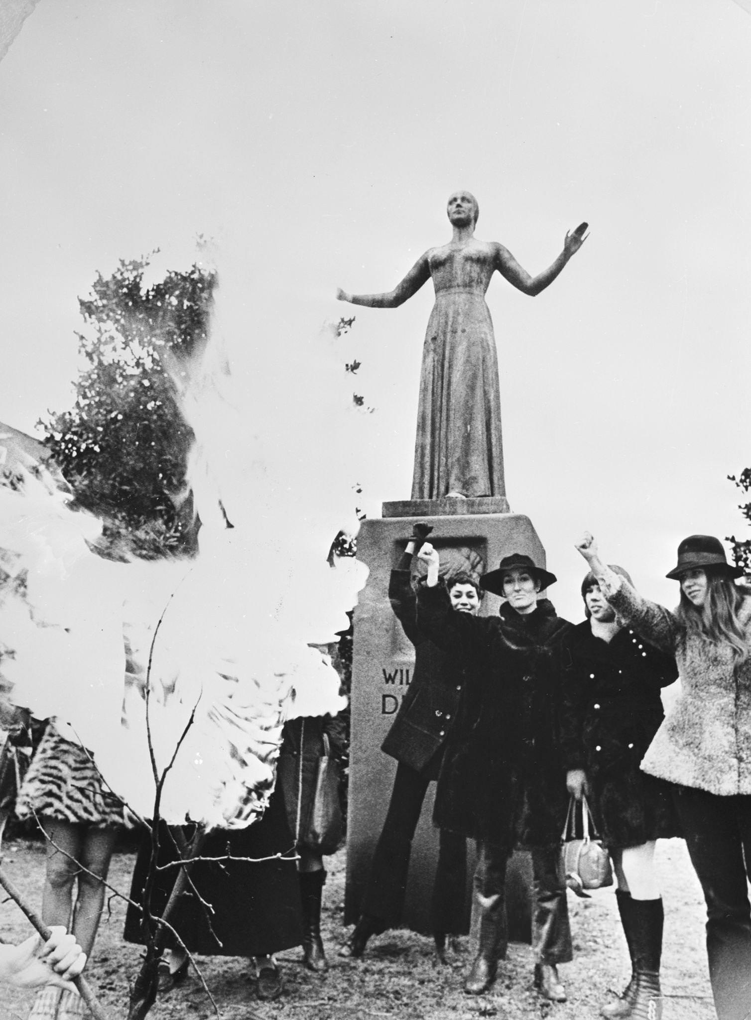 #80 Members of the Dutch branch of the Women’s Liberation Movement, the Dolle Mina, burn corsets beneath the statue of Dutch feminist Wilhelmina Drucker (Mad Mina) in Amsterdam, 1970s