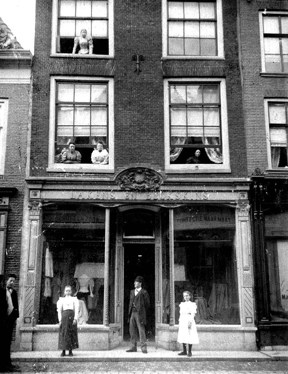 #15 People standing outside of a building on Langestraat in Alkmaar Netherlands, 1900