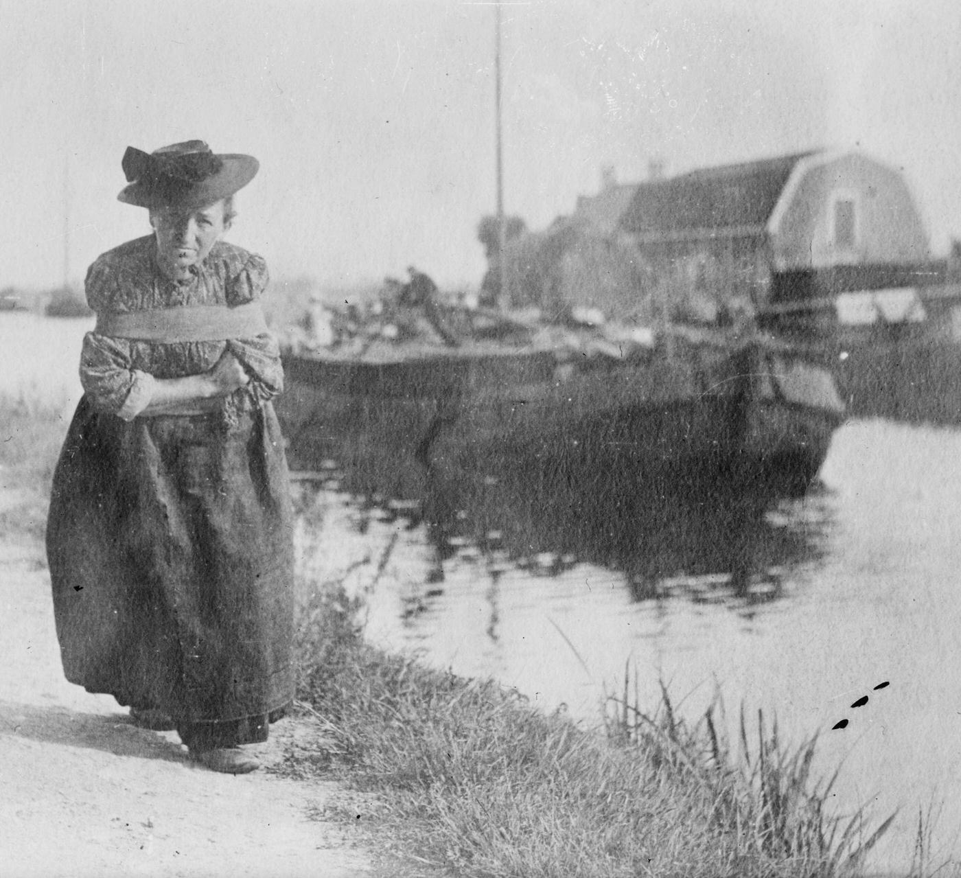 #84 An elderly Dutch woman pulling a barge down a canal, Netherlands, 1900