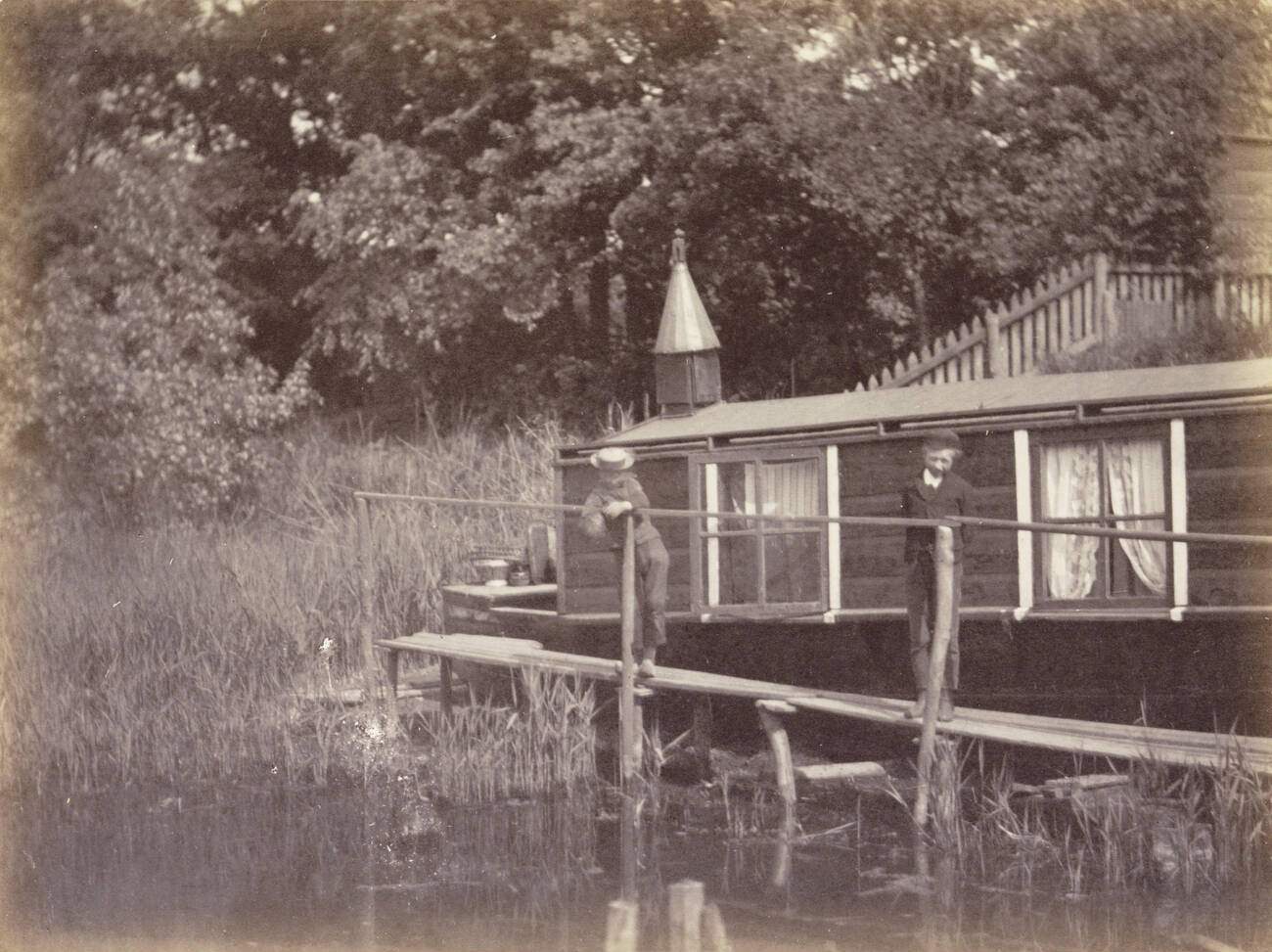 #94 Two boys on a jetty for a houseboat in Amsterdam, The Netherlands, 1900s