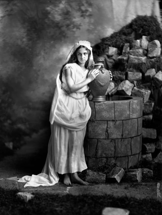 #17 Portrait of a young woman with urn by a well, 1910