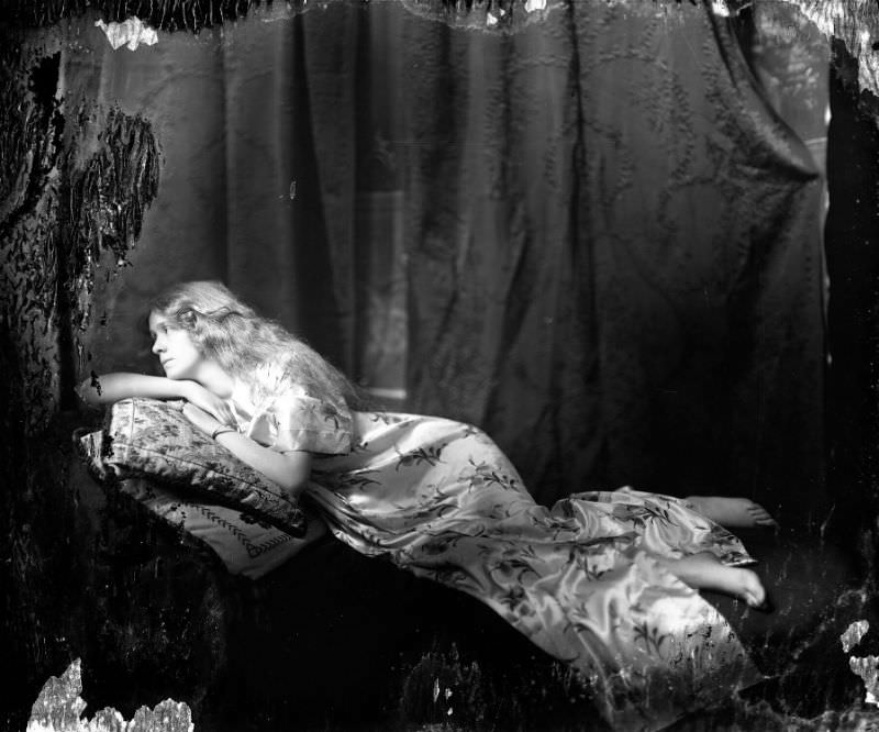 #25 Young woman posing on chaise lounge, 1910