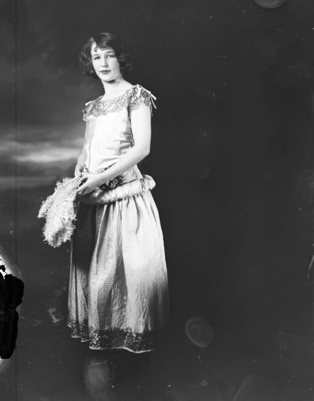 #29 Portrait of a young woman holding a feather fan, 1915