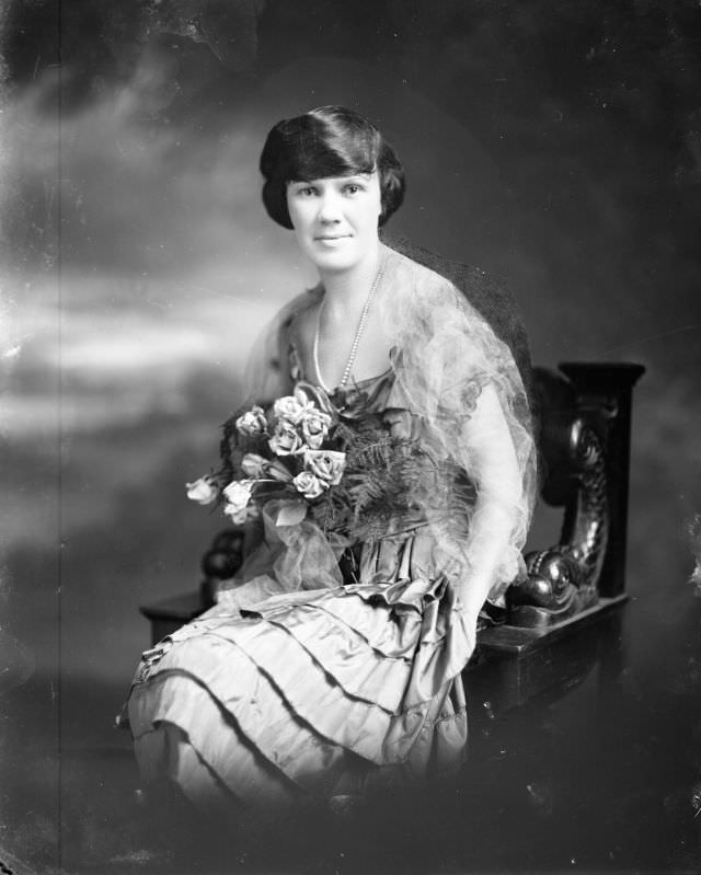 #7 Portrait of a young woman holding bouquet of roses., 1905