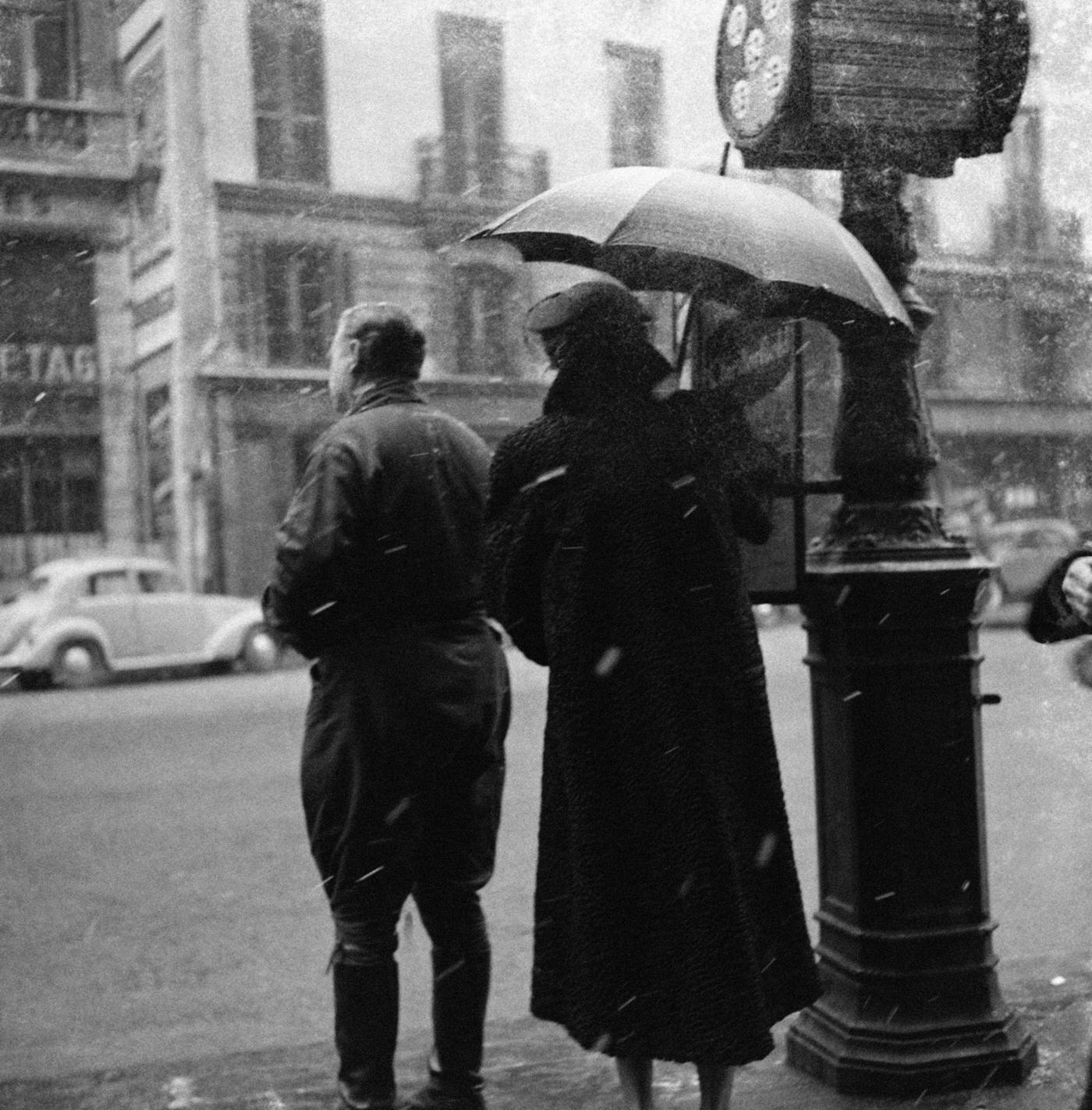 #54 Parisians Waiting At A Bus Stop Under Snow, Paris, 1954.