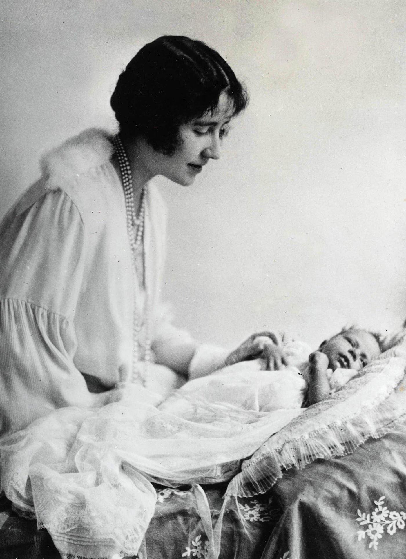 #1 Queen Elizabeth II as a baby of one month old, watched by her mother Queen Elizabeth, then the Duchess of York, May 1926.