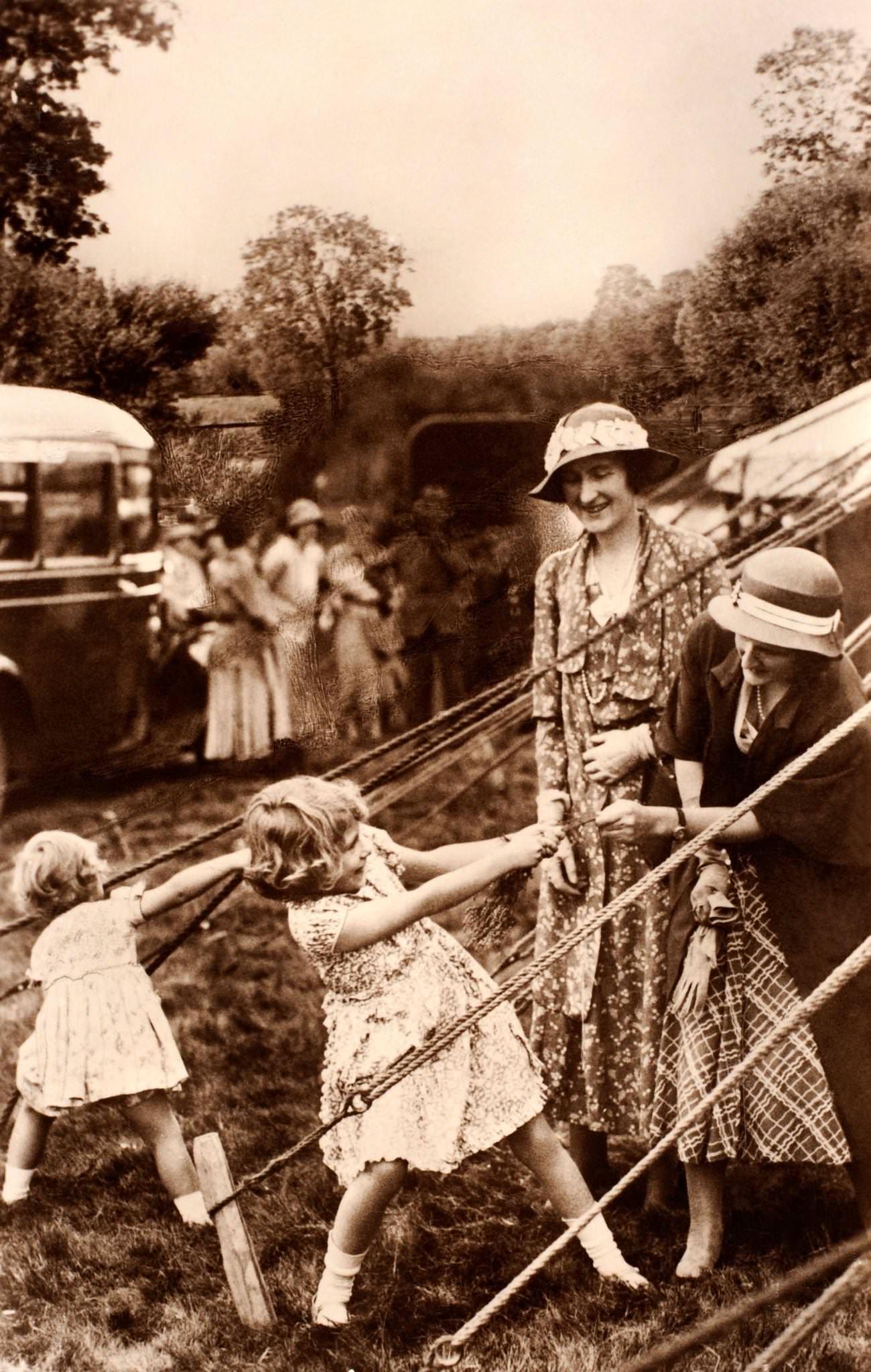 #26 Princess Elizabeth and her sister Margaret Rose at play, circa 1931.