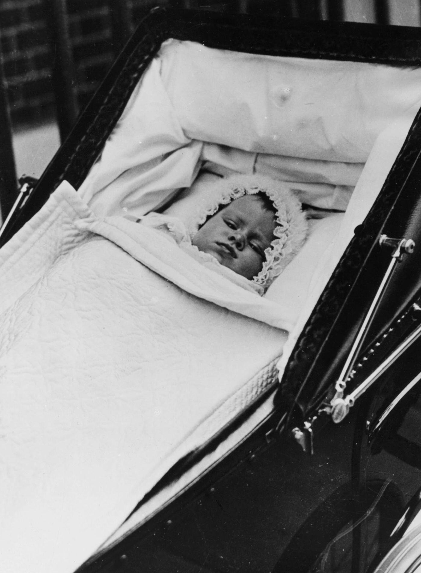 #7 Childhood portrait of Queen Elizabeth II lying in her pram, 1926.