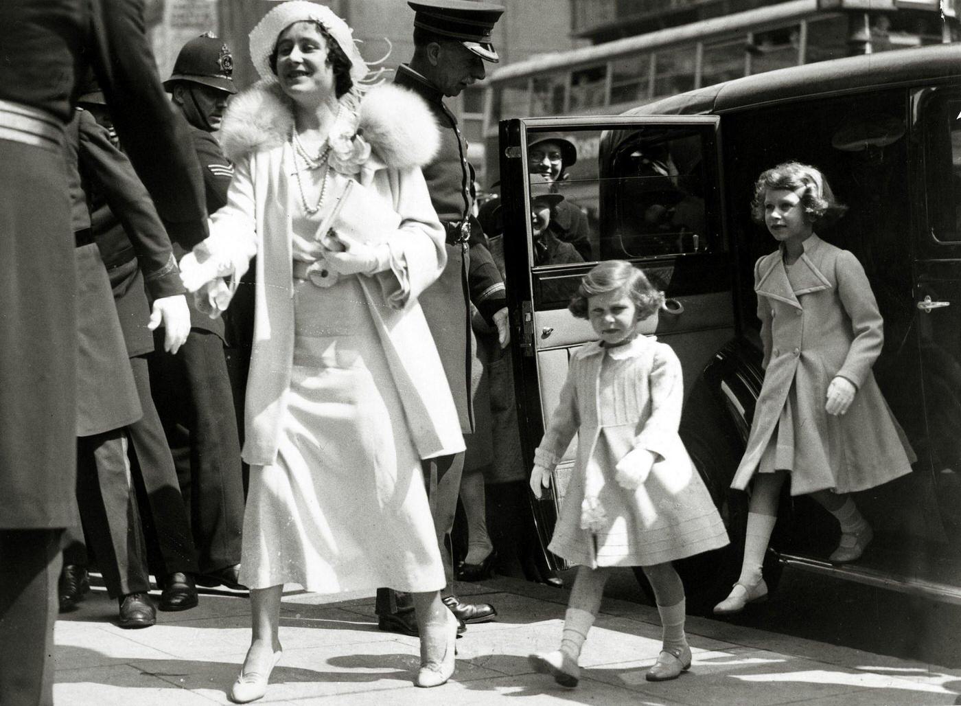 #74 The Duchess of York with her children Princess Margaret and Princess Elizabeth arriving at the Royal Tournament at Olympia, London.