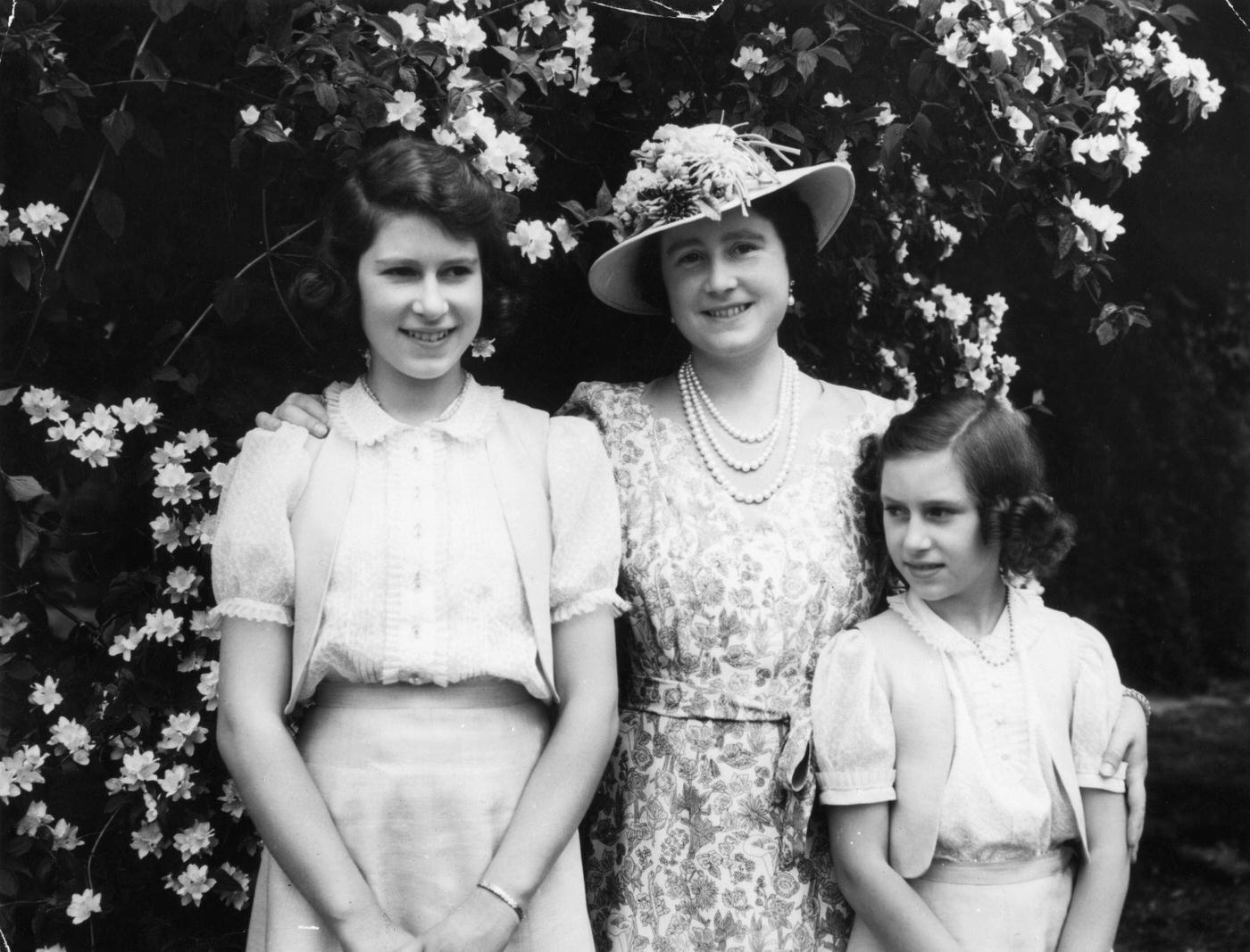 #104 Queen Elizabeth with her daughter Princess Elizabeth (later Queen Elizabeth II) and Princess Margaret in the garden at Windsor Castle during WW II.