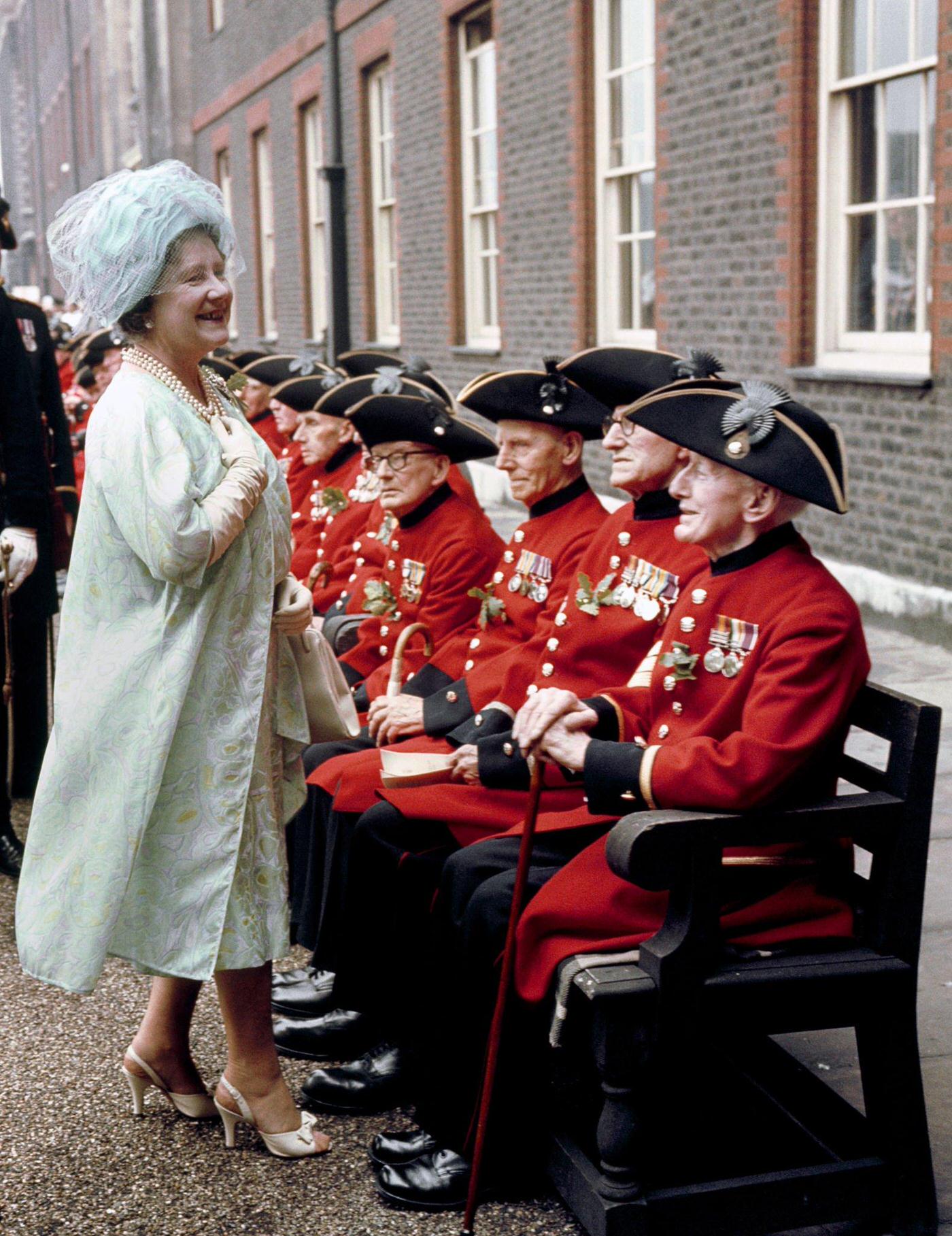 #117 Queen Elizabeth, The Queen Mother, talks to Boer War veterans among Chelsea pensioners at their Founder’s Day parade at the Royal Hospital, Chelsea, London, 1966.