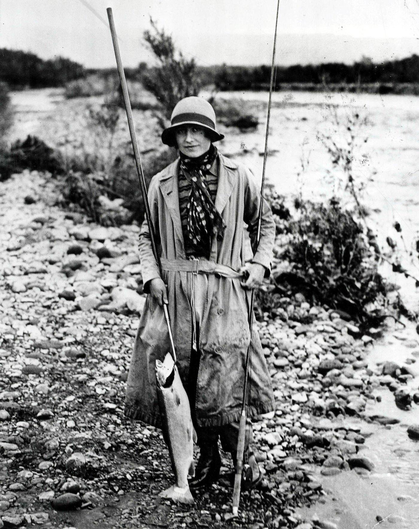 #67 Queen Mother Fishing: Royal tour of Australia and New Zealand, 1927, the Queen Mother, then the Duchess of York, holding a salmon she had caught after a fishing expedition at Tokaanu, New Zealand.
