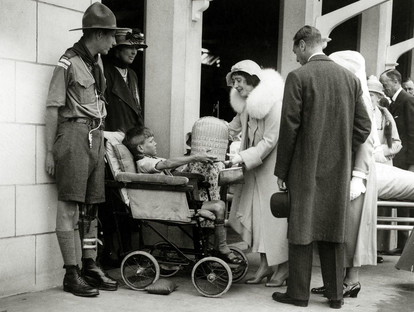 #78 Duke and Duchess of York speaking with a disabled boy at the newly opened Royal United Orthopedic Hospital in Bath, 1933.