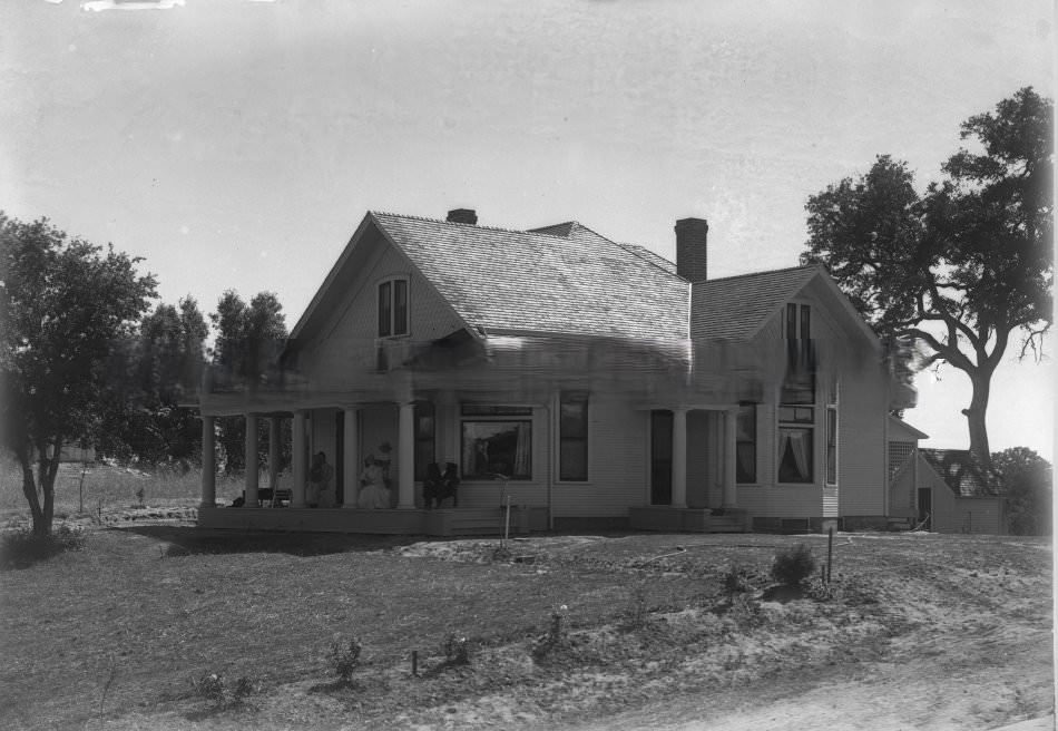 #184 Exterior view of three people sitting on the porch of a house in Fair Oaks, 1890