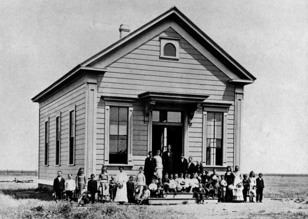 #219 Students and teachers standing in front of a school building, 1890