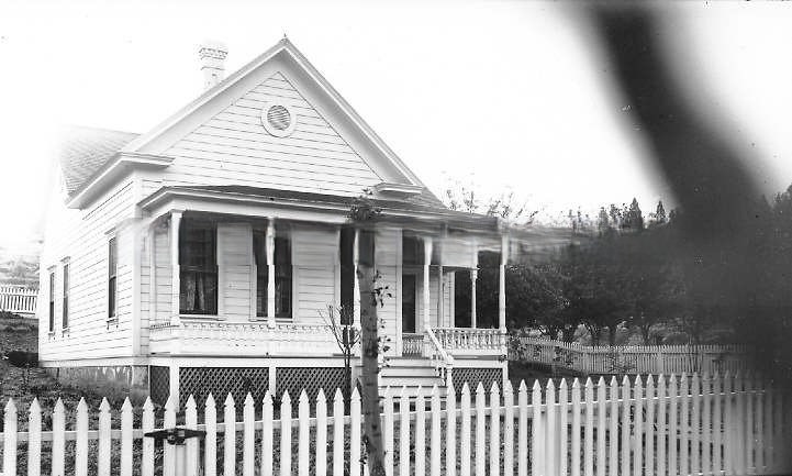 #52 Small Victorian-styled house with white picket fence, 1895