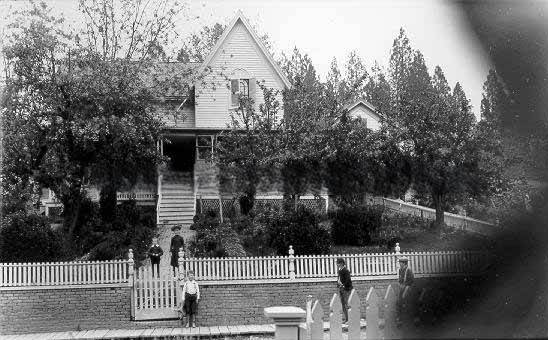 #61 House with white picket fence, 1895