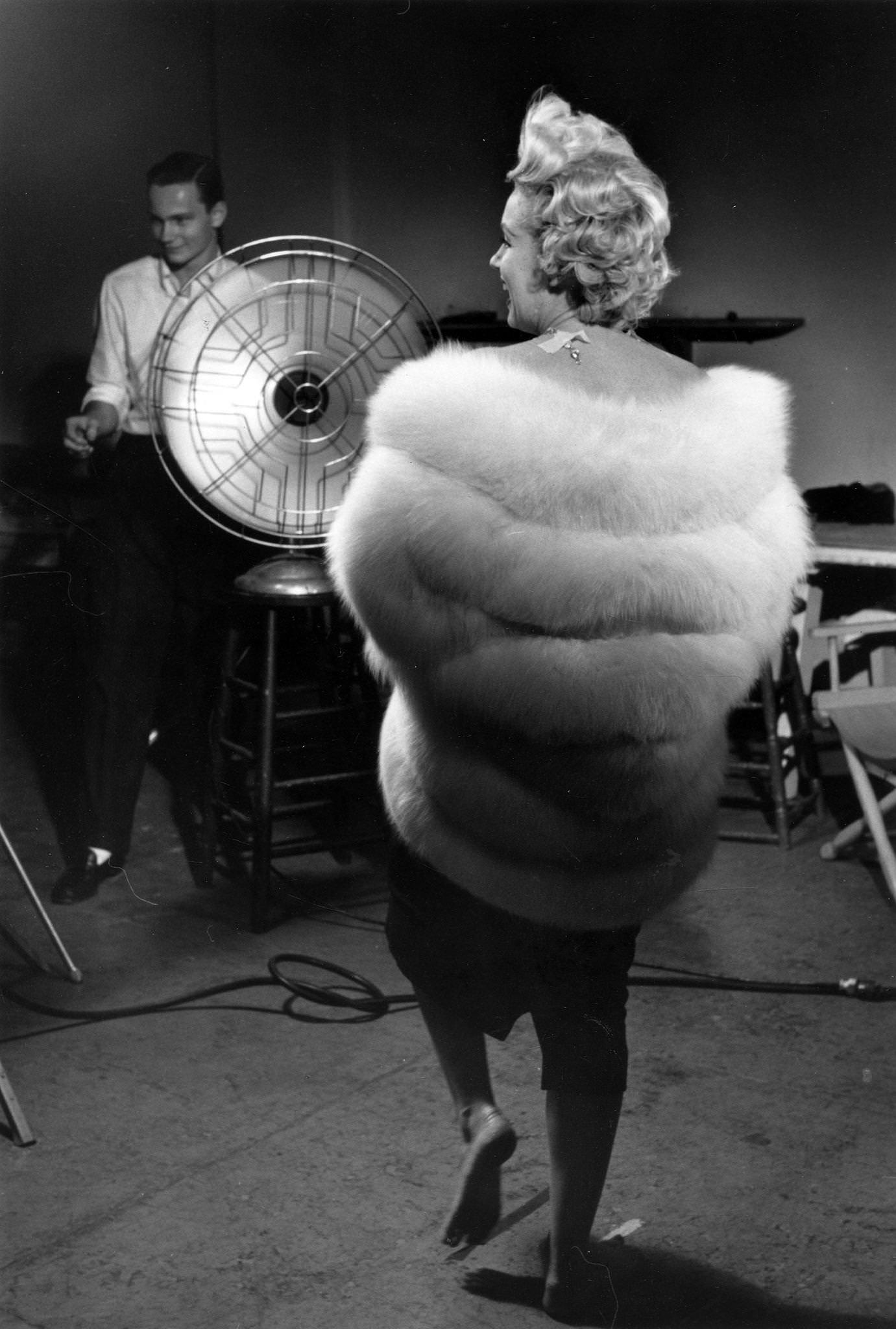 Marilyn Monroe wearing a white stole fur wrap prepares for a publicity photo shoot with Richard Avedon in his studio in 1954 during the filming of “The Seven Year Itch” in New York