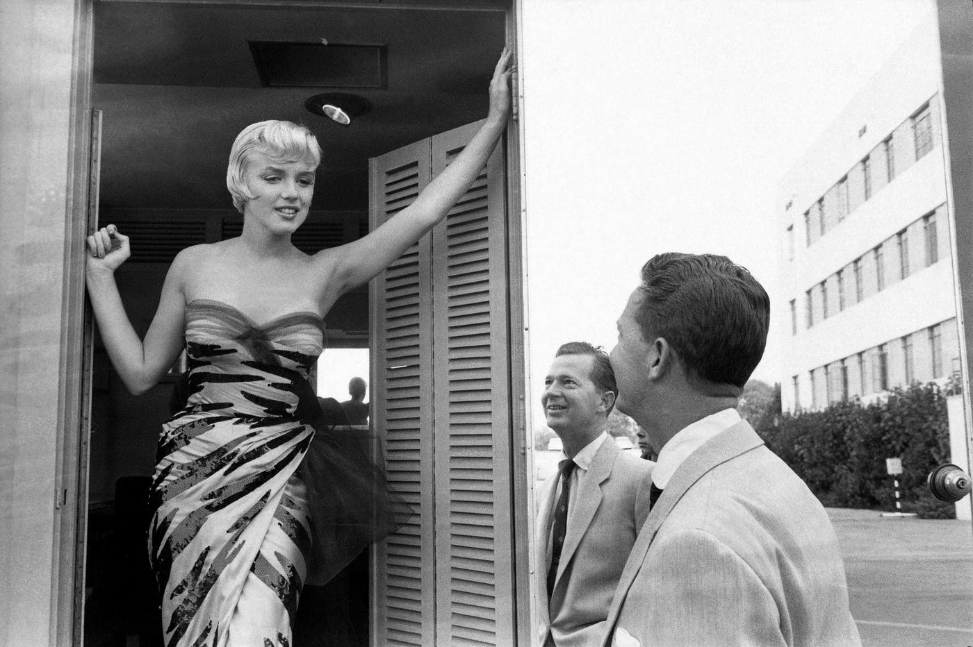 Marilyn Monroe stands in a doorway wearing a tiger-striped dress in 1954 during the filming of “The Seven Year Itch”