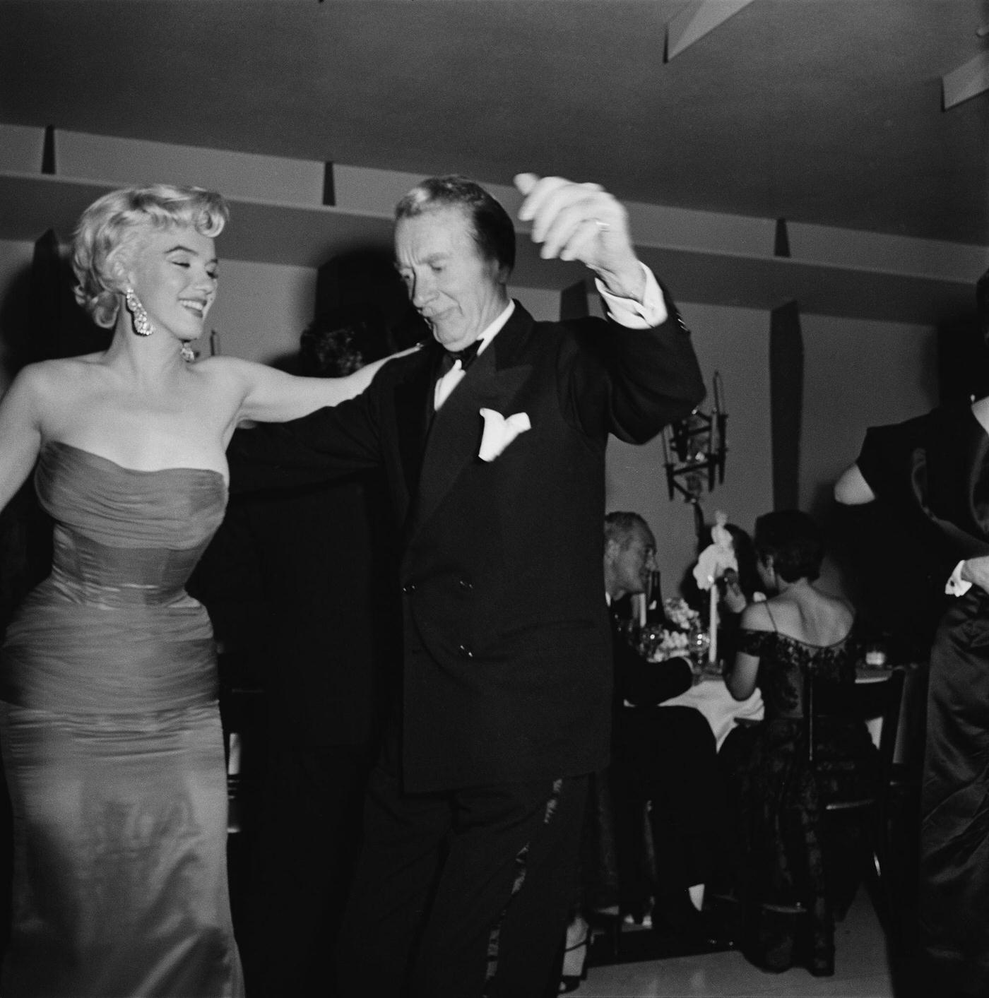 Marilyn Monroe dances with actor Clifton Webb at the wrap party for the filming of “The Seven Year Itch”