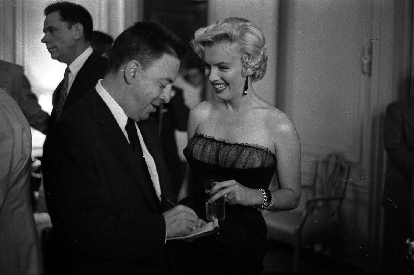 Marilyn Monroe with co-star Tom Ewell and newspaper columnist Earl Wilson at a press party for “The Seven Year Itch” in 1954 in New York