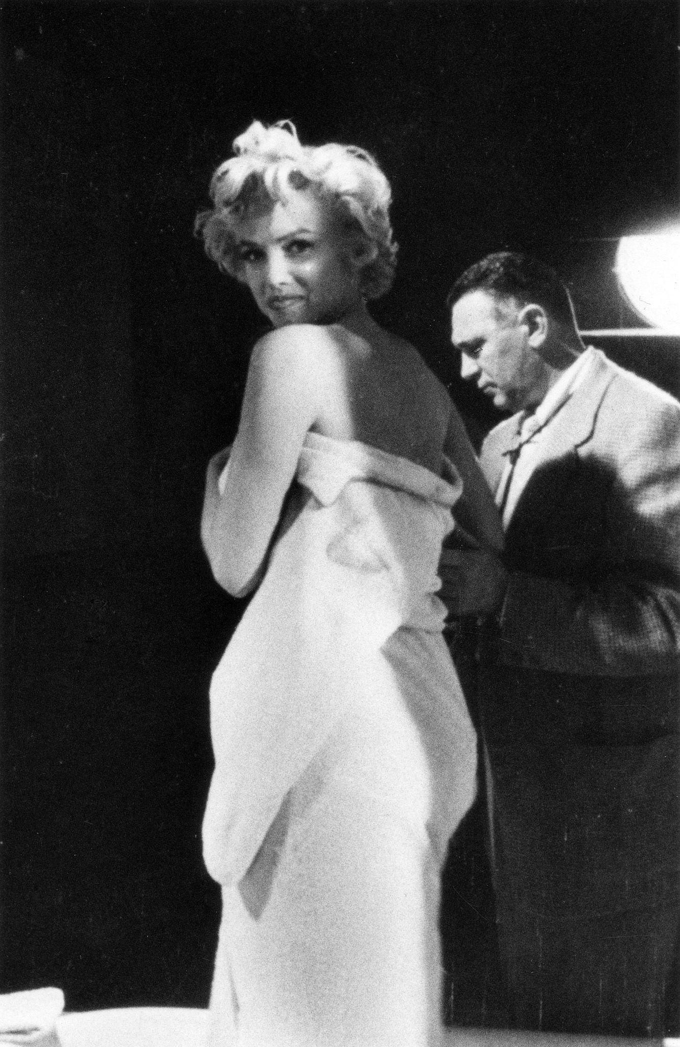 Marilyn Monroe prepares for a bathtub scene in 1954 on set with cinematographer Milton Krasner during the filming of “The Seven Year Itch” in Los Angeles
