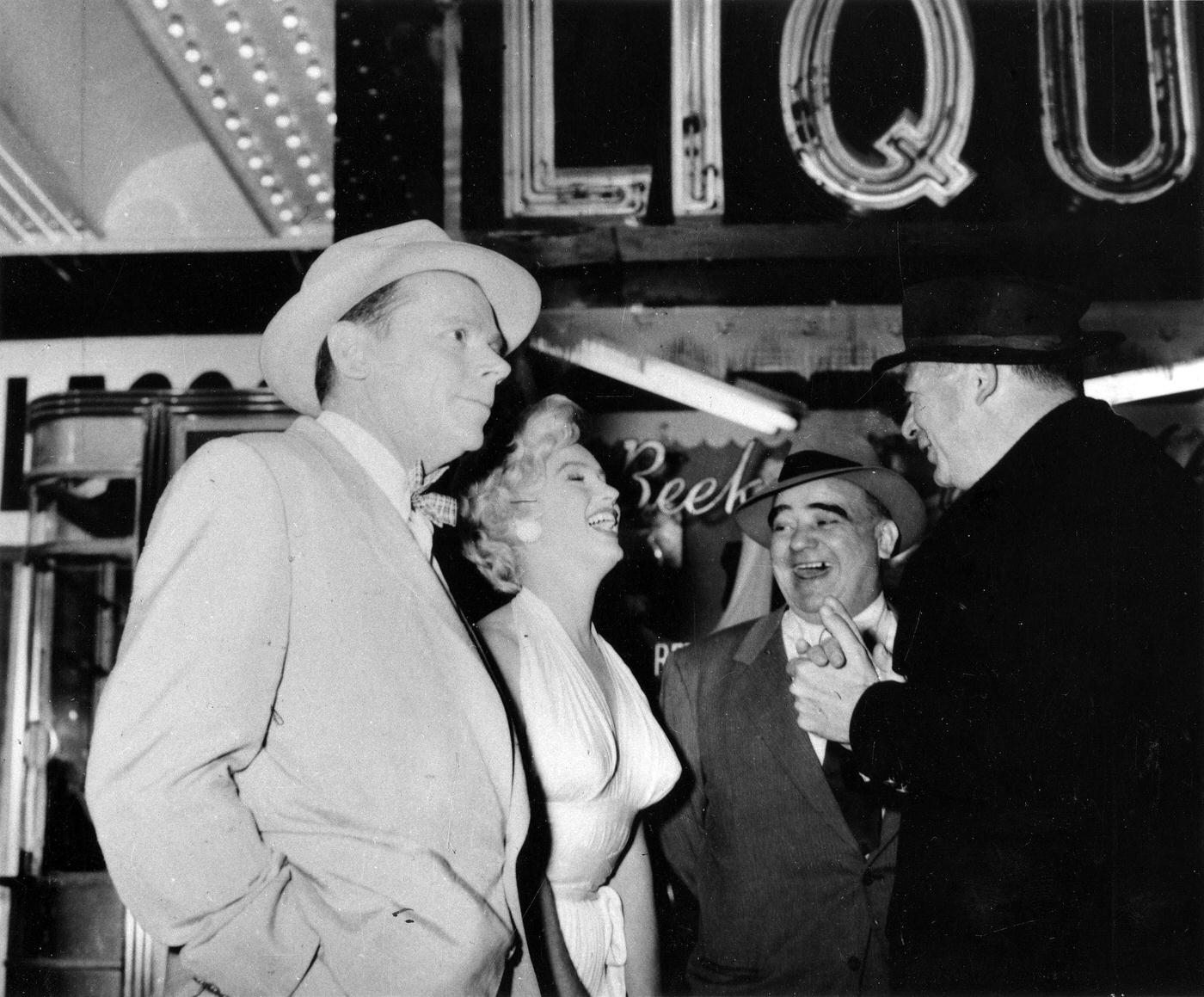 Marilyn Monroe with co-star Tom Ewell, production manager Johnny Graham, and director Billy Wilder on the corner of 51st Street and Lexington Avenue while filming the famous skirt-blowing scene for “The Seven Year Itch”
