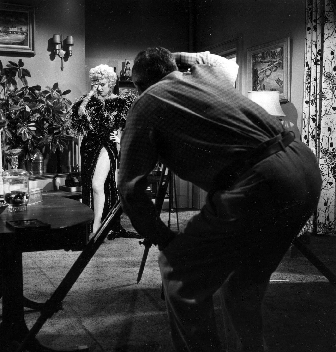 Marilyn Monroe in front of a camera wearing a feather boa during the filming of “The Seven Year Itch” in 1954